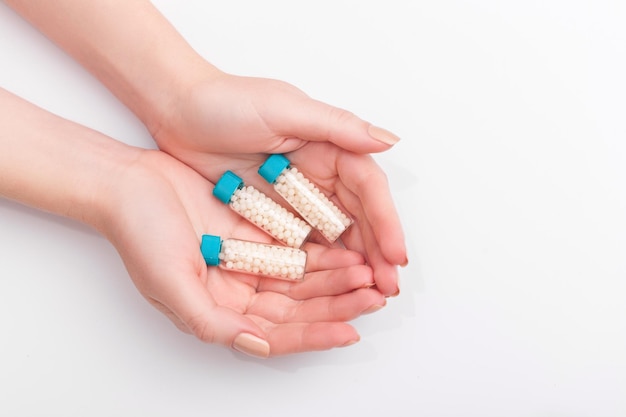 Imagem aproximada de medicamento homeopático que consiste em comprimidos e uma garrafa contendo um líquido homeo