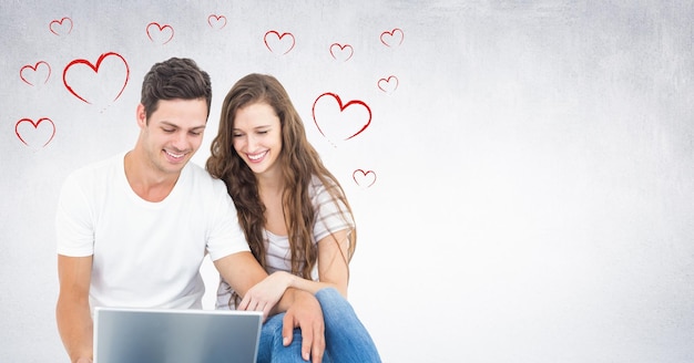 Imagem composta de casal feliz usando laptop