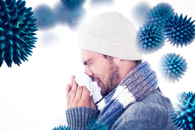 Foto imagem composta de homem bonito na moda de inverno assoando o nariz