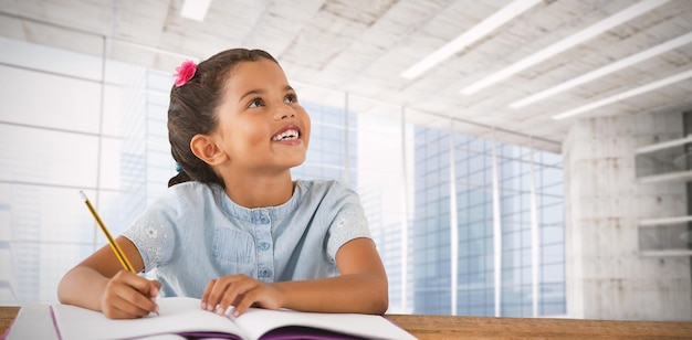 Foto imagem composta de menina olhando para cima enquanto está sentado na mesa