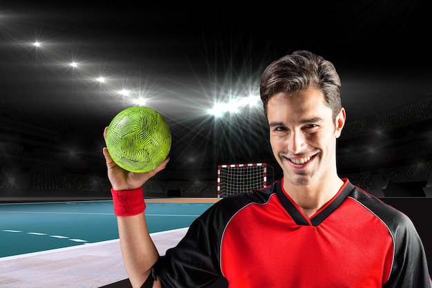 Imagem composta de retrato de homem atleta feliz segurando uma bola