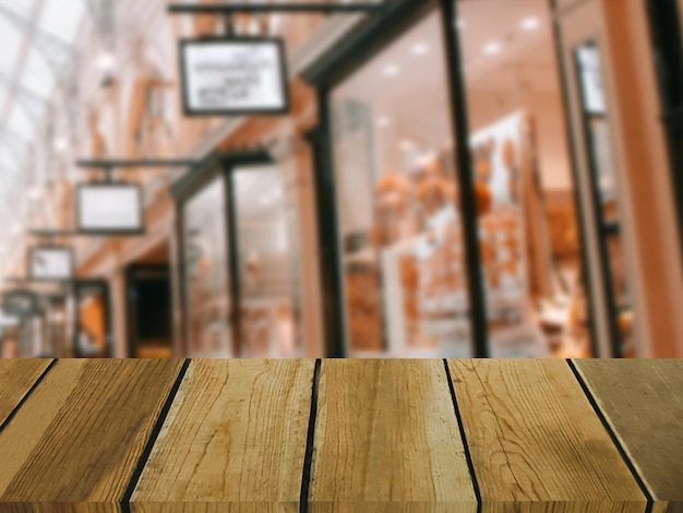 Imagem da mesa de madeira na frente do fundo desfocado abstrato das lojas do shopping