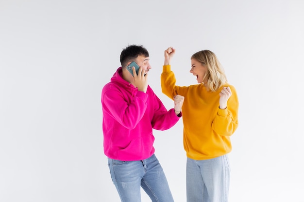 Imagem de casal amoroso otimista positivo isolado sobre fundo branco falando por telefones celulares