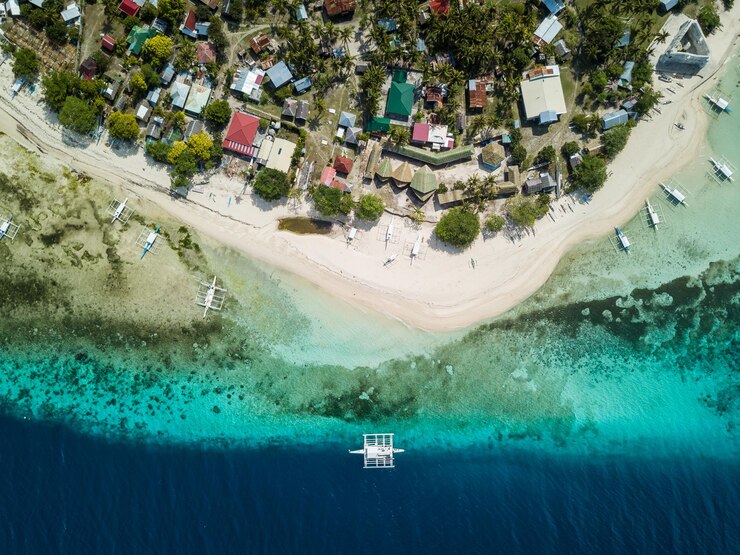 Foto imagem de um barco nas águas claras da ilha de pamilacan, nas filipinas.