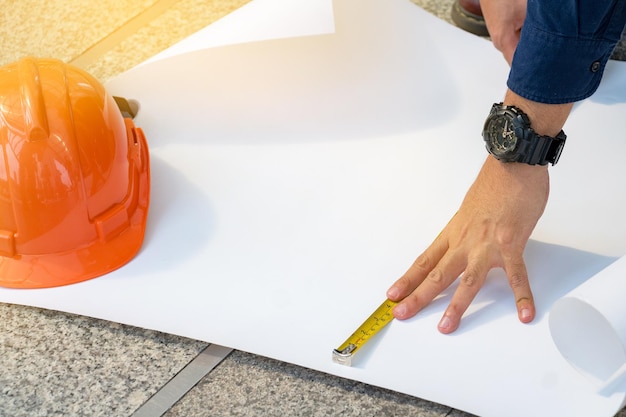 Foto imagem recortada de um engenheiro desenhando um plano no escritório