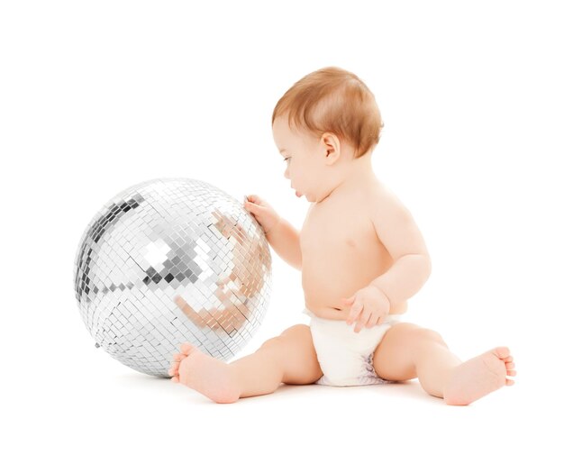 Imagen brillante de niño feliz jugando con bola de discoteca