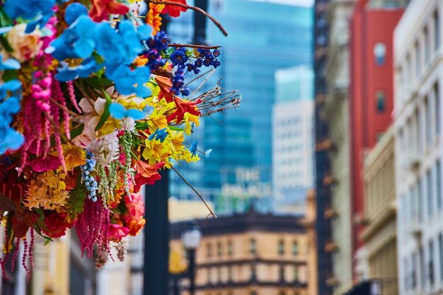 Foto imagen de una colorida variedad de flores en la mitad izquierda de la foto con edificios borrosos que conducen al palacio.