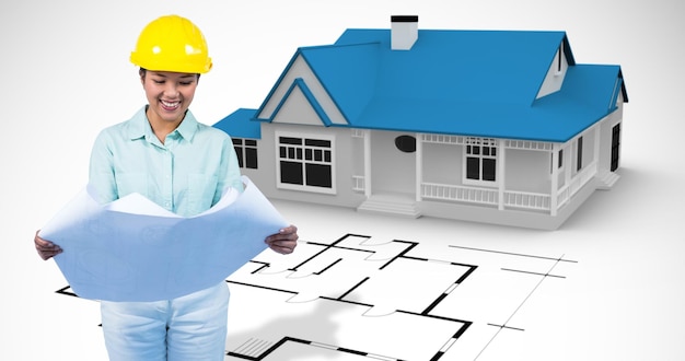 Imagen compuesta de arquitecto leyendo un plan con casco amarillo
