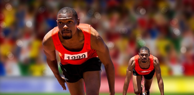 Imagen compuesta de atleta hombre en la parrilla de salida