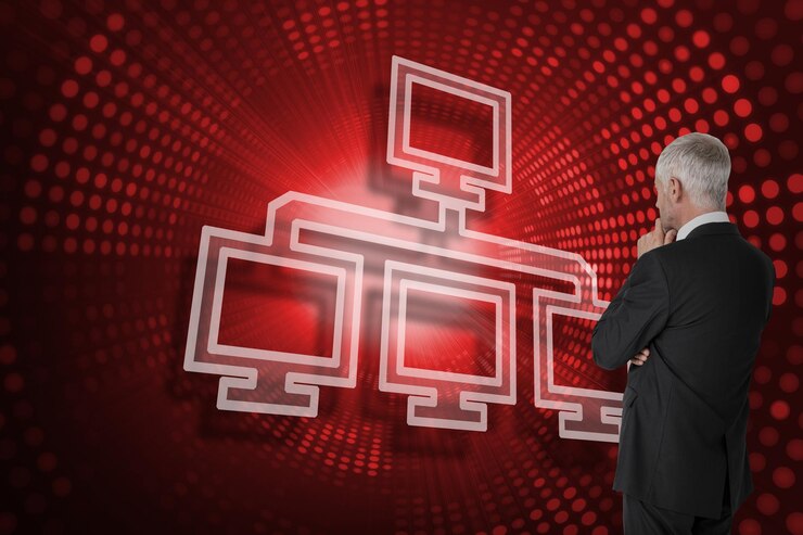 Foto imagen compuesta de conexión de computadora y hombre de negocios mirando contra la espiral de píxeles rojos