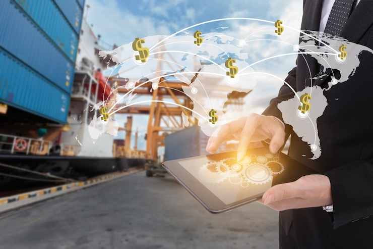 Foto imagen compuesta digital de un hombre de negocios usando una tableta digital con iconos en el muelle comercial