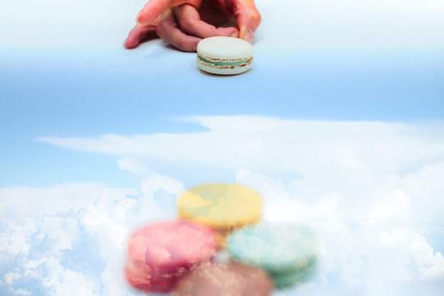 Imagen compuesta digital de una persona golpeando un macarrón y un cielo nublado