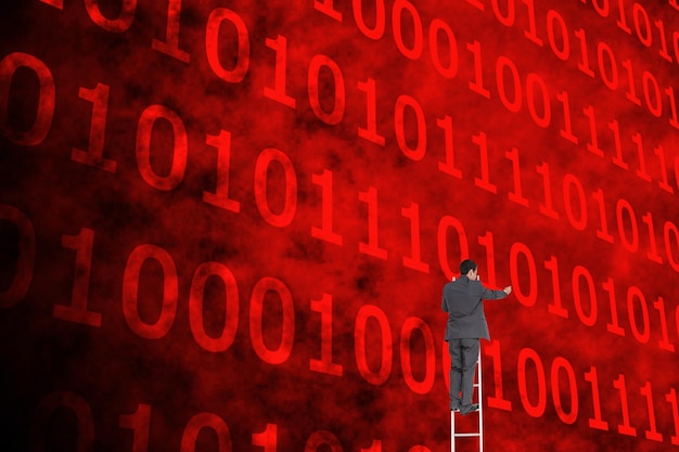 Imagen compuesta del empresario de pie en la escalera escribiendo