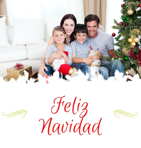 Imagen compuesta de familia feliz en la época navideña sosteniendo un montón de regalos