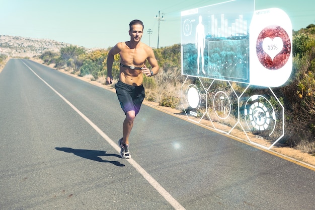 Imagen compuesta de hombre atlético trotar en carretera abierta con monitor alrededor del pecho