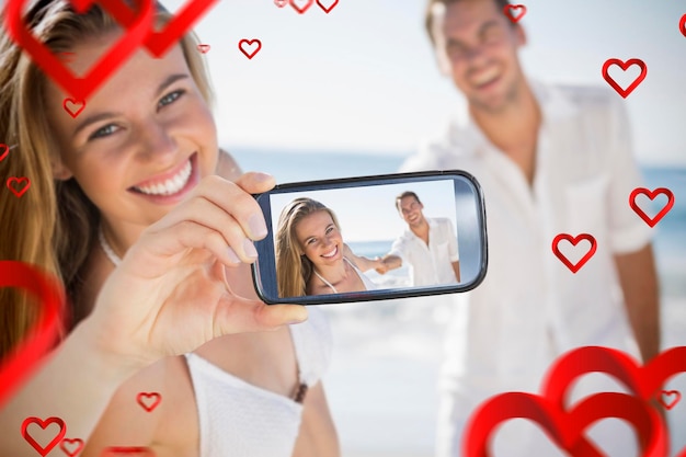 Imagen compuesta de pareja de San Valentín tomando un selfie