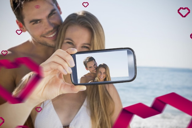 Imagen compuesta de pareja de San Valentín tomando un selfie