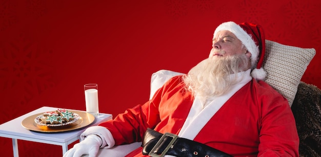 Foto imagen compuesta de santa claus relajándose en el sofá