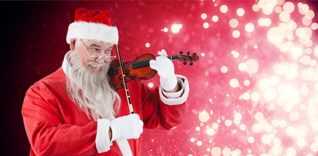 Imagen compuesta de santa claus sonriente tocando el violín