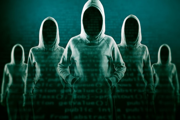 Imagen creativa de un grupo de piratas informáticos en sudaderas con capucha de pie sobre un fondo abstracto de codificación oscura Concepto de phishing y robo de malware Exposición doble