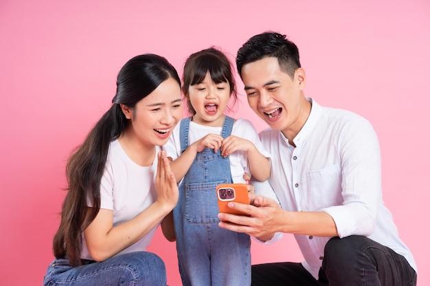 Imagen de familia asiática joven aislada sobre fondo rosa
