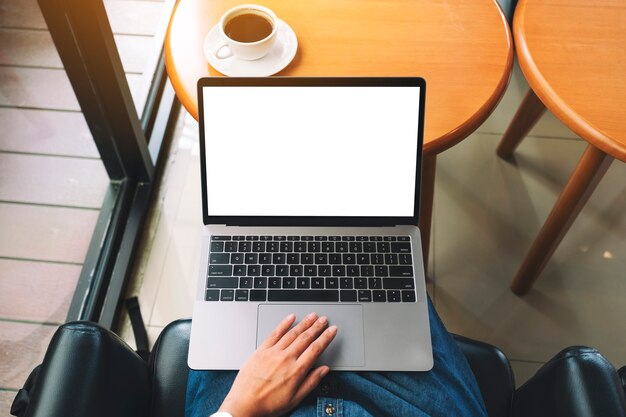 Imagen de maqueta de vista superior de una mujer usando y tocando el panel táctil de la computadora portátil con pantalla de escritorio blanca en blanco