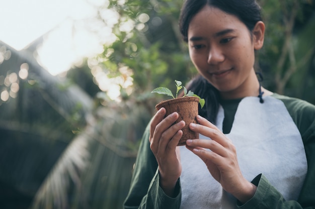 Imagen de una mujer asiática en el concepto de plantar árboles para el medio ambiente