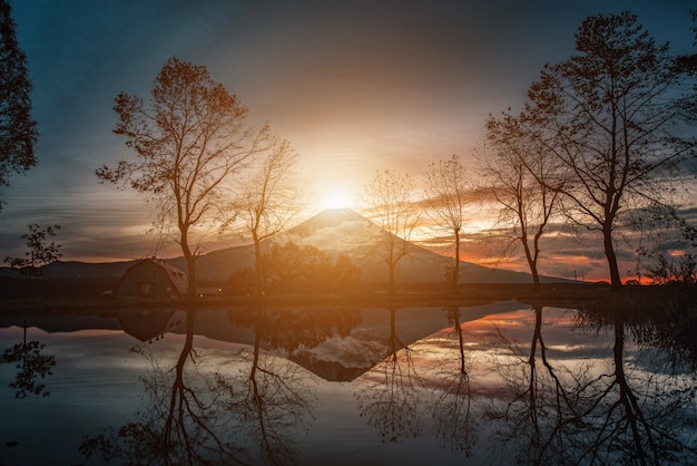 Foto imagen de paisajes del monte fuji con grandes árboles y lago al amanecer en el campo de fumotopara, fujinomiya, japón.
