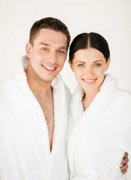 Imagen de una pareja en el salón de spa en albornoces blancos