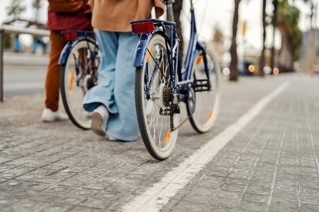 Imagen recortada de amigos empujando bicicletas en la calle