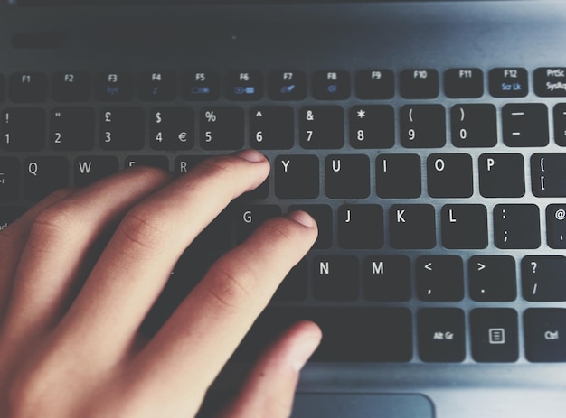 Imagen recortada de escritura a mano en una computadora portátil