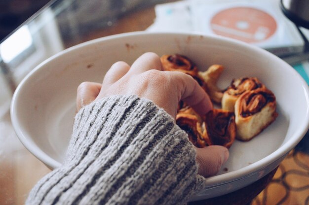 Foto imagen recortada de una mano sosteniendo comida