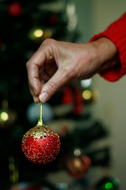 Imagen recortada de una persona celebrando el árbol de Navidad