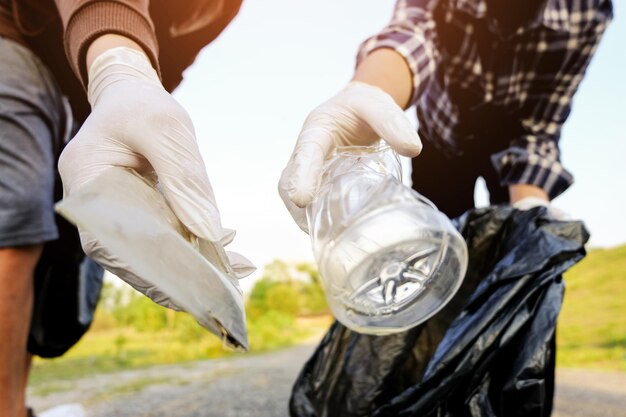 Foto imagen recortada de personas recogiendo basura en bolsas de plástico