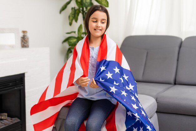 imágenes de una niña encantadora sobre el fondo de la bandera de Estados Unidos.