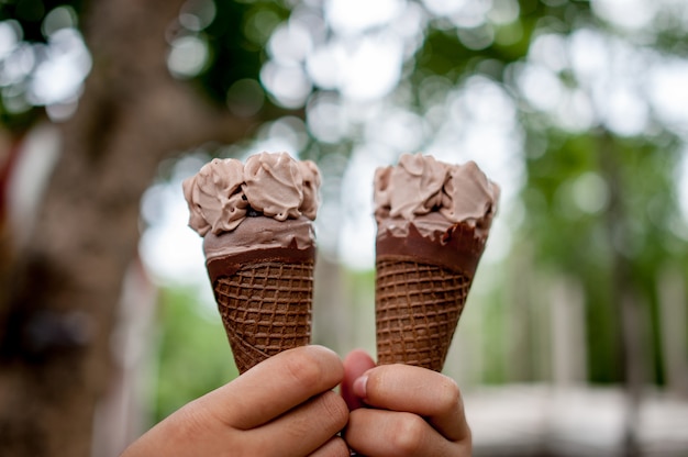 Imagens de mão e sorvete de chocolate, conceito de comida com espaço de cópia