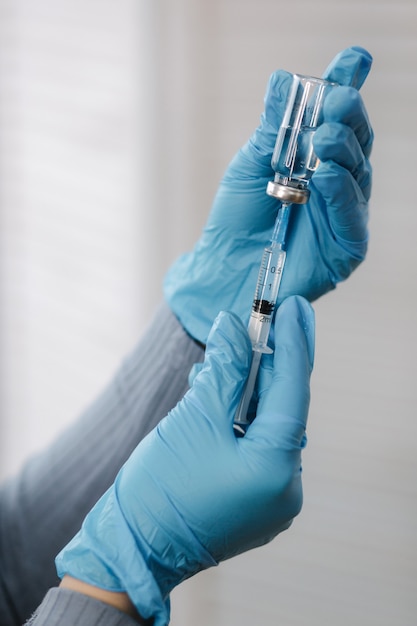 Impfstoff in Händen Ärztin hält Spritze und Flasche mit Covid-Impfstoff für Coronavirus-Heilung