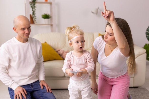 Implante coclear en la cabeza de la niña y jugando con la madre y el padre Audífonos y sordera y concepto innovador de tecnología de la salud