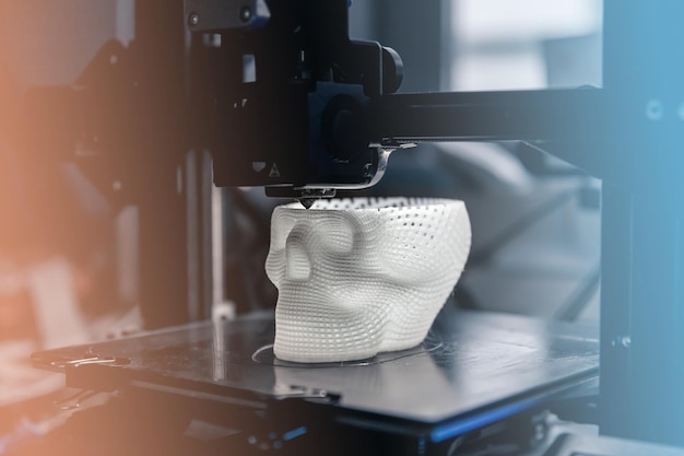 La impresora 3D imprime un modelo de plástico blanco