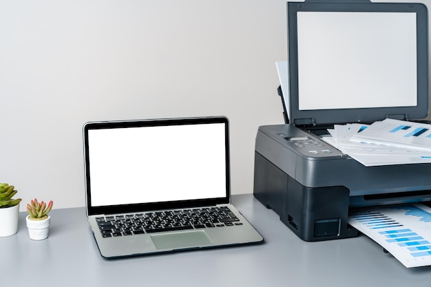 Foto impressora e portátil na mesa cinzenta do escritório