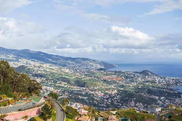 Increíble ciudad de Funchal en la isla de Madeira cerca de la vista panorámica del océano La montaña y las casas con cielo nublado