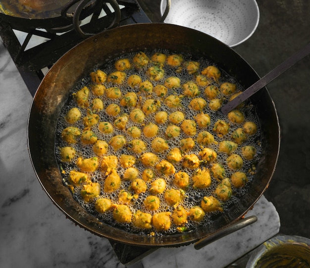 Indian Street Food Fritura Pakora ou Bhajiya em óleo