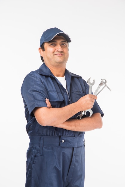 Indio feliz mecánico de automóviles en traje azul y gorra