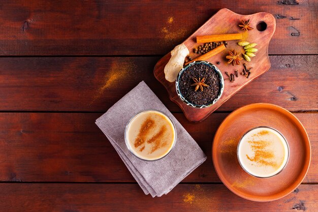 Indischer Masala Chai Tee mit Gewürzen in Tassen