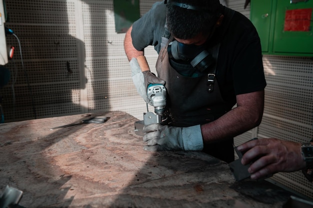 Industriearbeit während einer Pandemie. Zwei Männer arbeiten in einer Schwermetallfabrik und tragen aufgrund einer Coronavirus-Pandemie eine Maske im Gesicht. Hochwertiges Foto