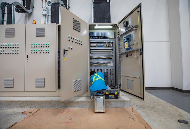 El ingeniero electricista prueba el control de la caja eléctrica