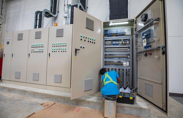 El ingeniero electricista prueba el control de la caja eléctrica