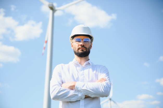 Ingeniero está comprobando la producción de energía en turbinas eólicas Trabajador en parque de molinos de viento