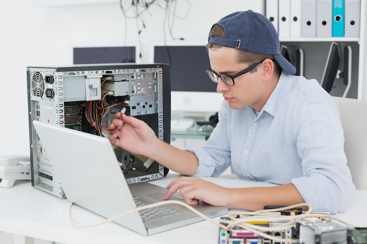 Foto ingeniero informático trabajando en consola rota con laptop