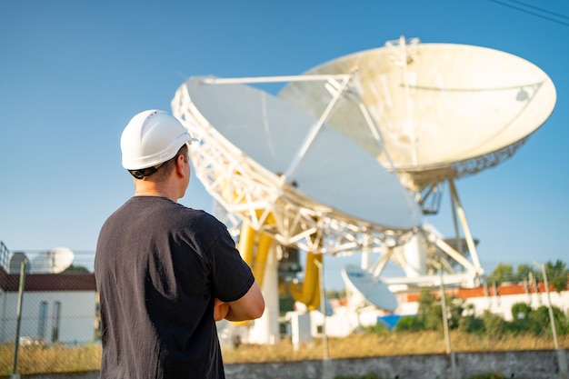 Ingeniero mirando radiotelescopio astronómico basado en la tierra